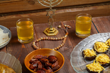 Shabbat table with traditional holiday food menorah