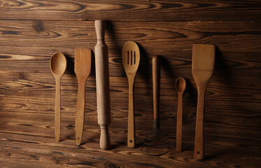 Set of wooden eco kitchen utensils on boards.