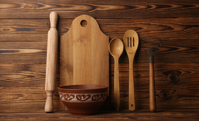 Ceramic bowl and Set of wooden eco kitchen utensils on boards.