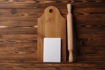 White card and Set of wooden eco kitchen utensils on boards.