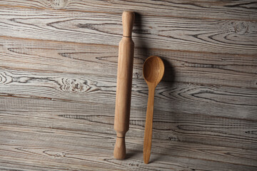 Wooden rolling pin with spoon on boards