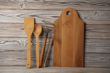 Set of wooden eco kitchen utensils on boards.
