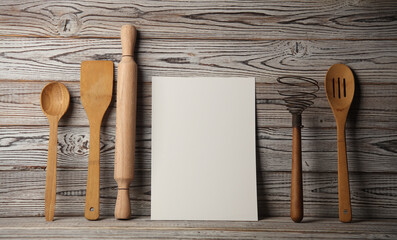 White card and Set of wooden eco kitchen utensils on boards. - obrazy, fototapety, plakaty
