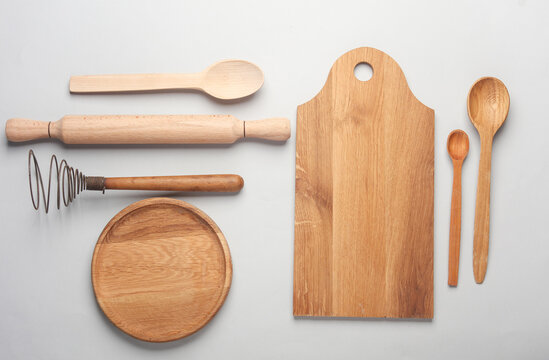 Set of wooden eco kitchen utensils on white background. Flat lay. Top view
