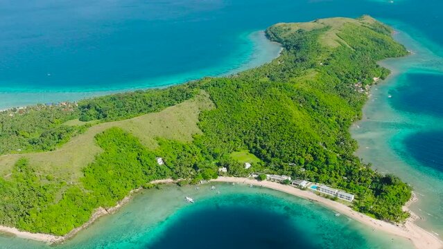 Aerial view of Logbon Island surrounded by blue sea. Blue sky and clouds. Romblon, Romblon. Philippines.
