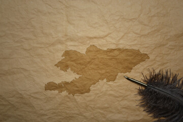 map of kyrgyzstan on a old paper background with old pen