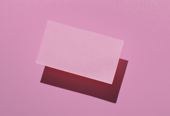 Pink Blank business card for corporate identity on pink background. Creative mockup.