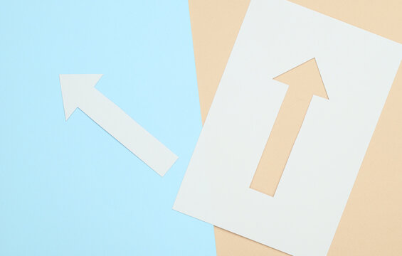 Arrows cut from paper on a pastel background