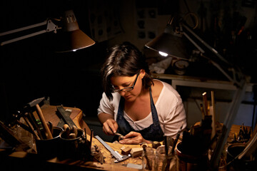 Artist, woman and tools with woodwork in workshop with craftsmanship, skill and handmade design with creativity. Wood, carpenter or creative person at workspace with equipment for handicraft or hobby