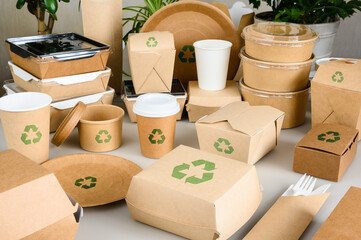 Biodegradable food packaging with recycling marks. Paper disposable environmentally friendly tableware.