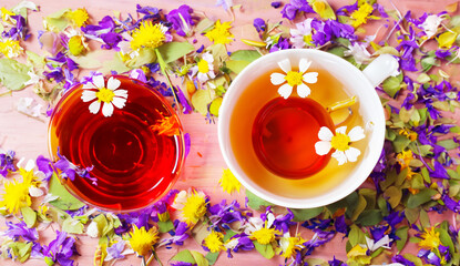 herbal tea in a cup, fresh flowers in the background, morning tea or herbal medicine concept