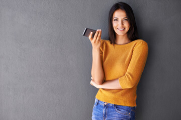 Woman, phone and wall background for mockup, smile and portrait in fashion for social media. Technology, digital and interent with female person and mobile in studio for online, typing and connection