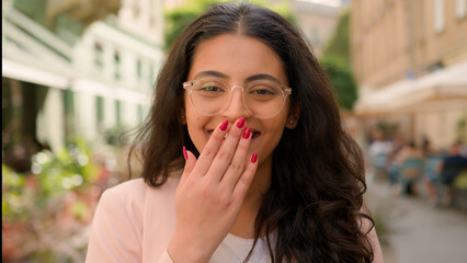 Close up happy amazed excited woman Indian Arabian female girl shocked smiling lady businesswoman in city surprised open mouth shock business success achievement win victory wonder surprise outdoors