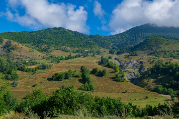 Fototapeta na wymiar Mystical Highlands: Green Mountain Ranges Kissed by the Blue Skies