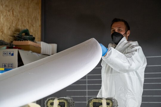 Shaper working on surf board