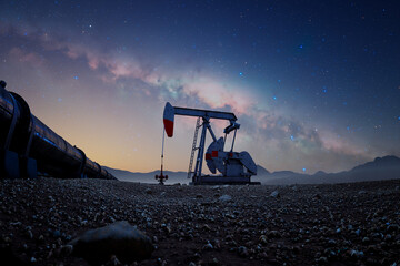 Industrial Oil Pumpjack Working Through the Night Under a Starlit Sky