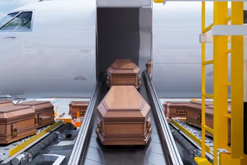 Zelfklevend Fotobehang Airport Cargo Terminal Handling Deceased's Coffins on Conveyor Belt © Dabarti