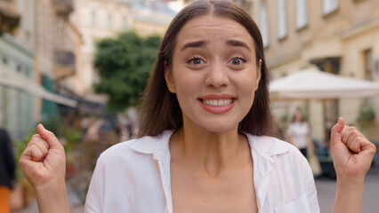 Close up portrait European surprised woman open mouth shocked caucasian girl city outside gen z female smiling success achievement win victory wonder cheerful joyful lady amazement expression street