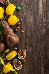 Easter joy composition: Top view vertical shot of chocolate eggs opened up to show colorful sweets,...