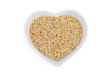 Sesame seeds in ceramic bowl isolated on white background. Top view. Flat lay