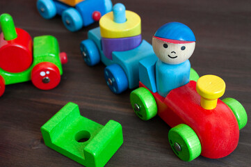 Wooden multicolored blocks in a form of train with a driver in it. Educational toys
