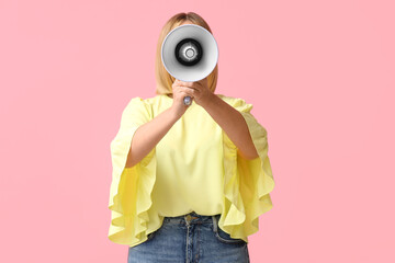 Fototapeta premium Mature woman with megaphone on pink background