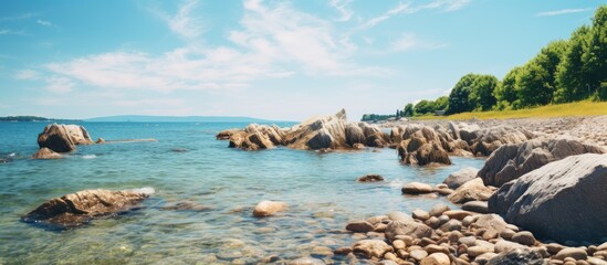 Serene Coastal Scene with Jagged Rocks and Glistening Waters at the Rocky Shoreline