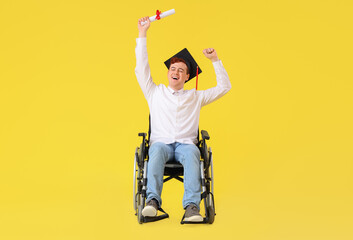 Happy male graduate in wheelchair with diploma on yellow background