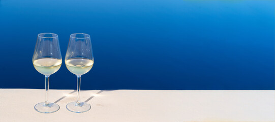 two glasses of wine with Aegaen sea in background