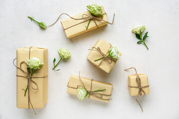 Many gift boxes with beautiful roses on white background. International Women's Day