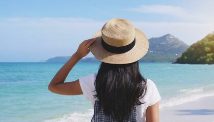 woman in hat looking on tropical beach