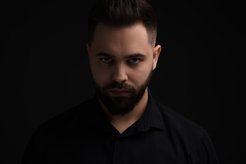 Evil eye. Man with scary eyes on black background