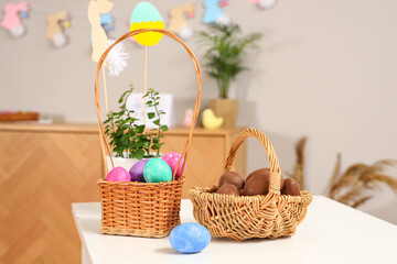 Fototapeta na wymiar Baskets of chocolate eggs on table at decorated for Easter home
