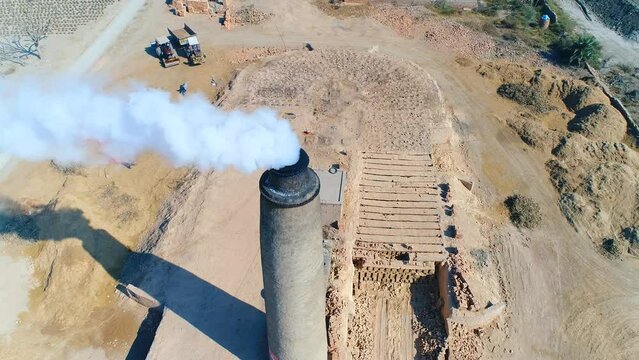 Static view single factory chimneys processing plant release white smoke. Pollution of air and atmosphere by bricks factory. The pipes of factory emit dirty smoke. bricks making factory. Drone View