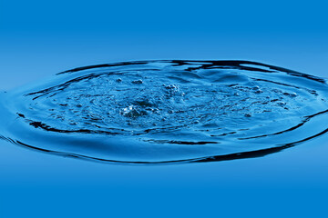A ripple in the water with bubbles in blue