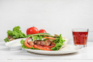 Plate with tasty doner kebab on  table