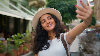 Happy smiling Indian Arabian ethnic woman girl female student tourist traveler influencer taking...