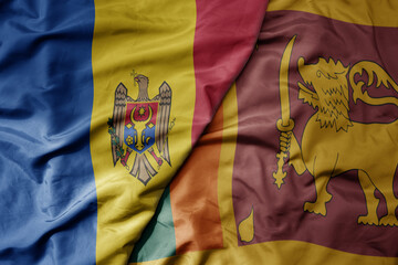big waving national colorful flag of sri lanka and national flag of moldova .