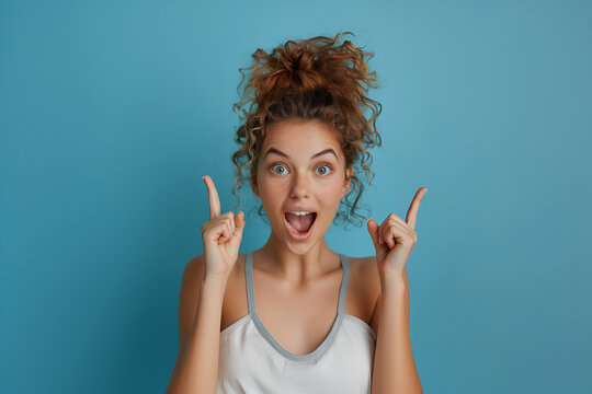 Portrait of nice astonished person open mouth direct fingers up empty space proposition isolated on blue color background