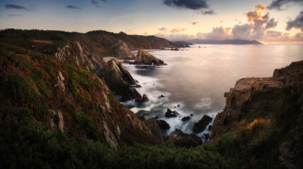 ultra wide, long exposure panoramic wiev of the north coast of galicia, spain, at the sunset. 
