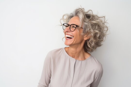 Close up portrait of a happy senior woman with wavy hair laughing
