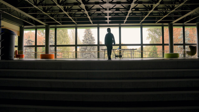 Back view girl climbing steps stairs kindergarten back to school little child kid daughter alone student learner schoolgirl with backpack corridor hall lessons study education weekend inside arrival