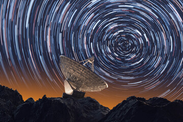 Star Trails Circling the Night Sky Above a Lone Satellite Dish