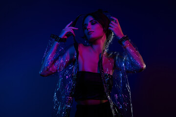 Photo of attractive cool lady wear plastic rubber jacket protecting from rainstorm over vivid background