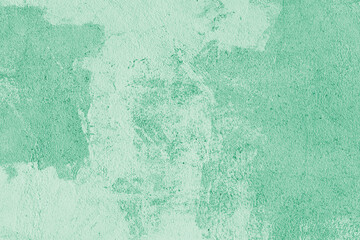 Old stucco plaster surface, concrete wall background, close up grunge texture of green painted cement texture. Wallpaper, backdrop, architecture design element