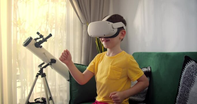Little boy is immersed in cyberspace, learning to fight in virtual reality. Child plays games. Teaching child using virtual reality headset. Kid using virtual reality glasses. Face close-up with smile