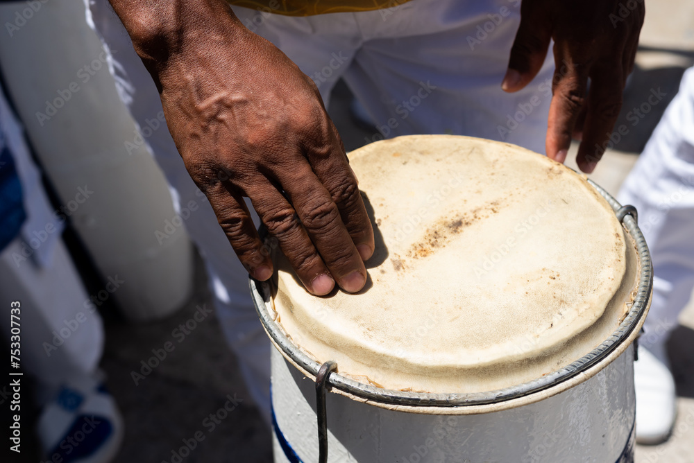 Wall mural percussionist's hands resting on top of the atabaque.