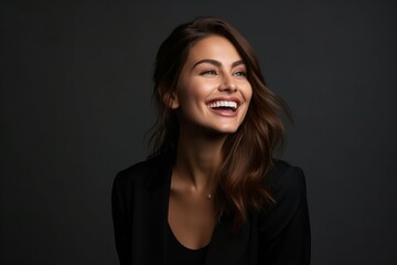 Portrait of a beautiful young woman laughing and looking at the camera