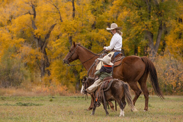 Mother  and Son cowgirl and Cowboy riding and talking
