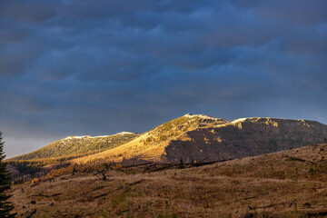 Alpen glow on mountains with storm clouds